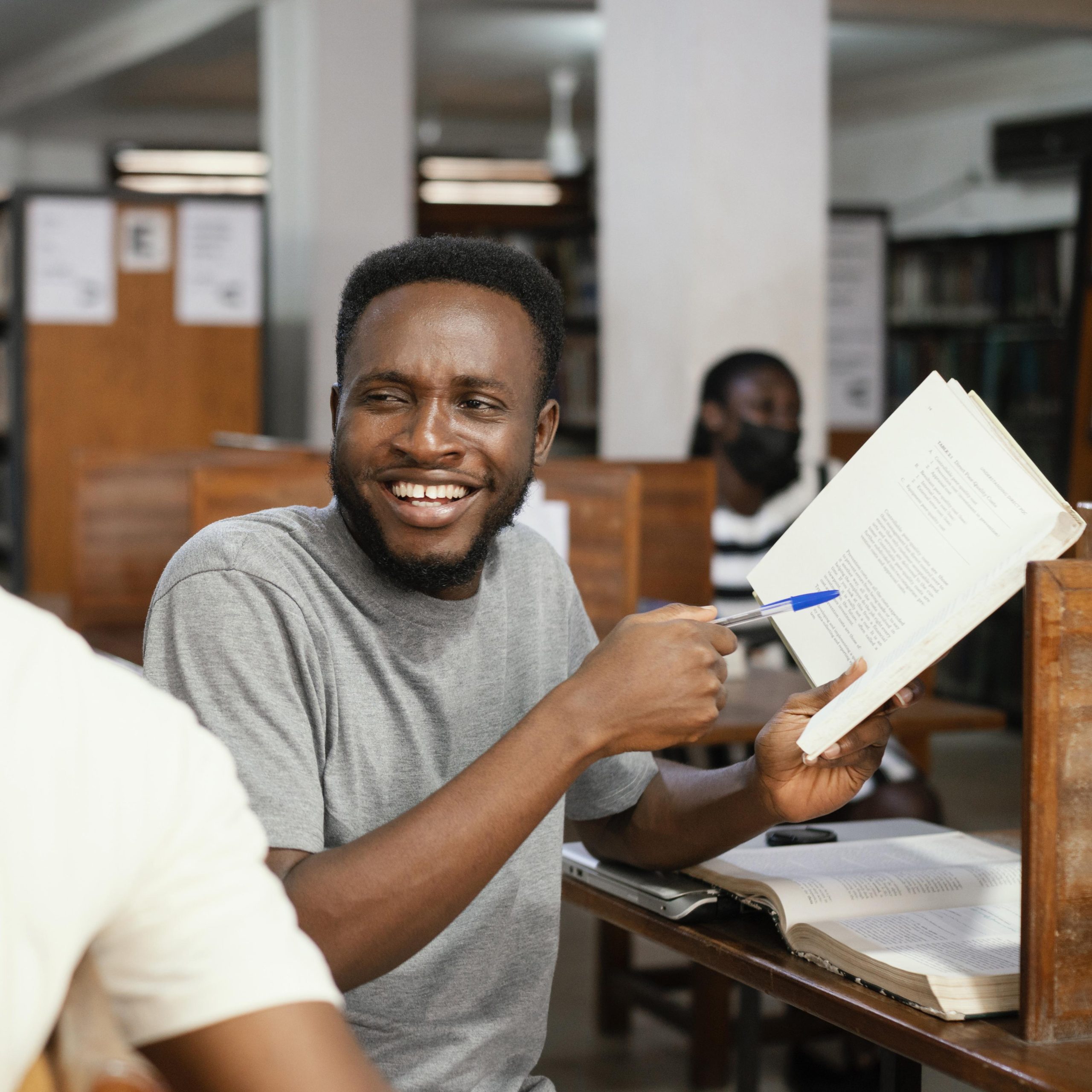close-up-smiley-student-holding-book